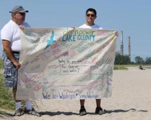 Clean Power Lake County volunteers hold "We Are Waukegan" canvas banner