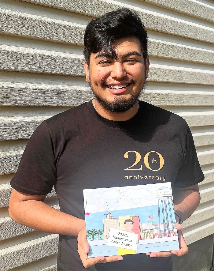 Eddie Flores poses with environmental coloring book.